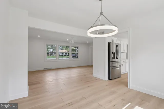 a view of a room with wooden floor and windows