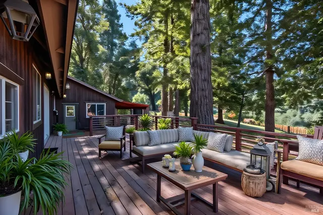a view of a balcony with wooden fence and floor