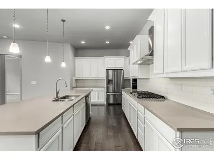 a kitchen with stainless steel appliances a sink stove and cabinets