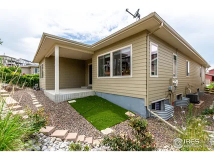a view of a house with backyard and sitting area