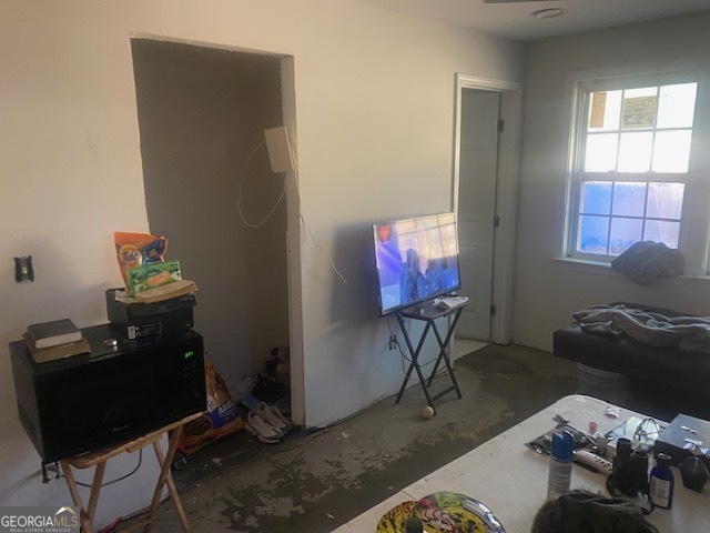 1573 Campbellton Road Southwest Atlanta, GA 30311 - Photo 12 of 22 a living room with furniture a rug and a window