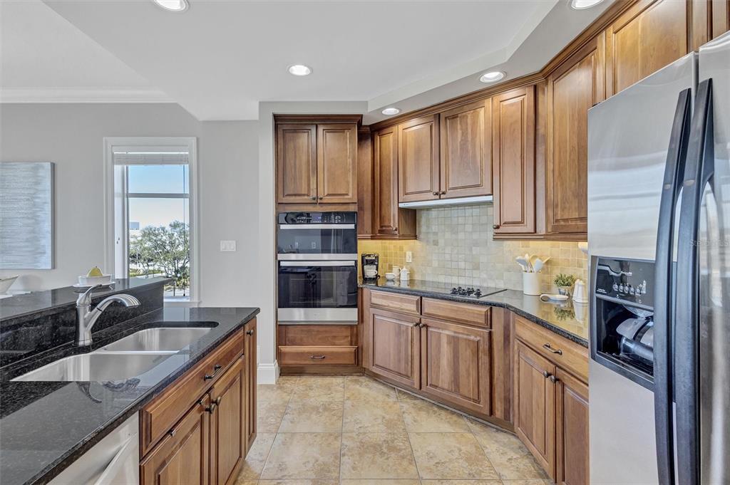 140 Riviera Dunes Way, Unit 206 Palmetto, FL 34221 - Photo 11 of 46 a kitchen with stainless steel appliances granite countertop a sink stove and cabinets