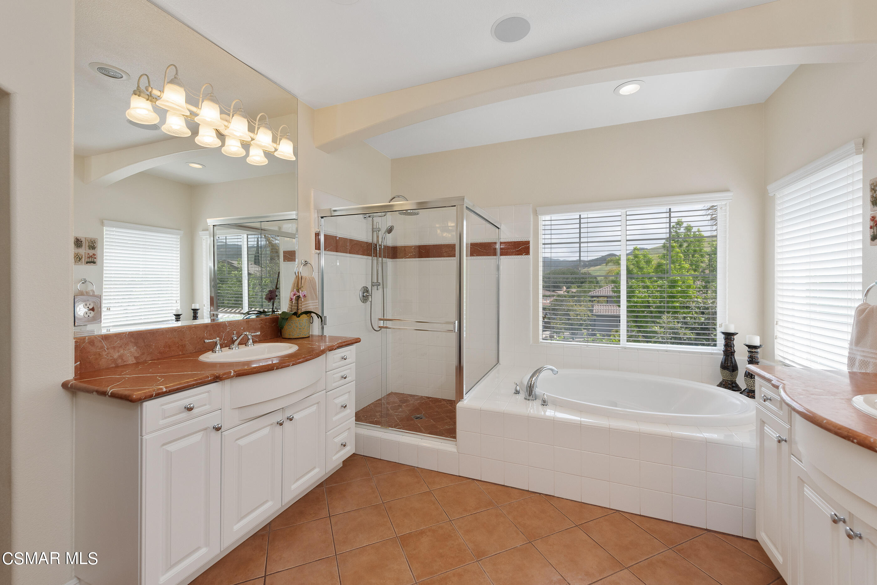 128 Laurel Ridge Drive Simi Valley, CA 93065 - Photo 44 of 66 a bathroom with a granite countertop sink a large mirror and a bathtub with shower