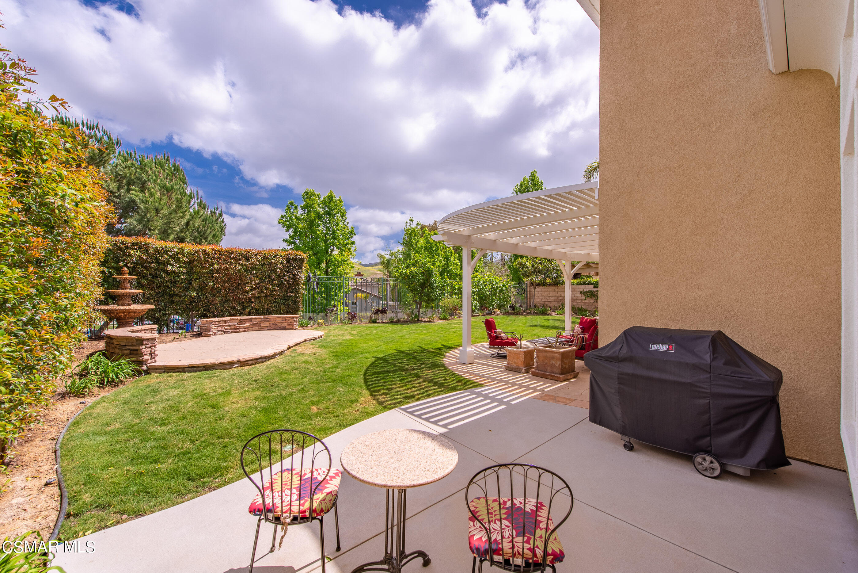 128 Laurel Ridge Drive Simi Valley, CA 93065 - Photo 51 of 66 a view of a patio with table and chairs potted plants and a large tree