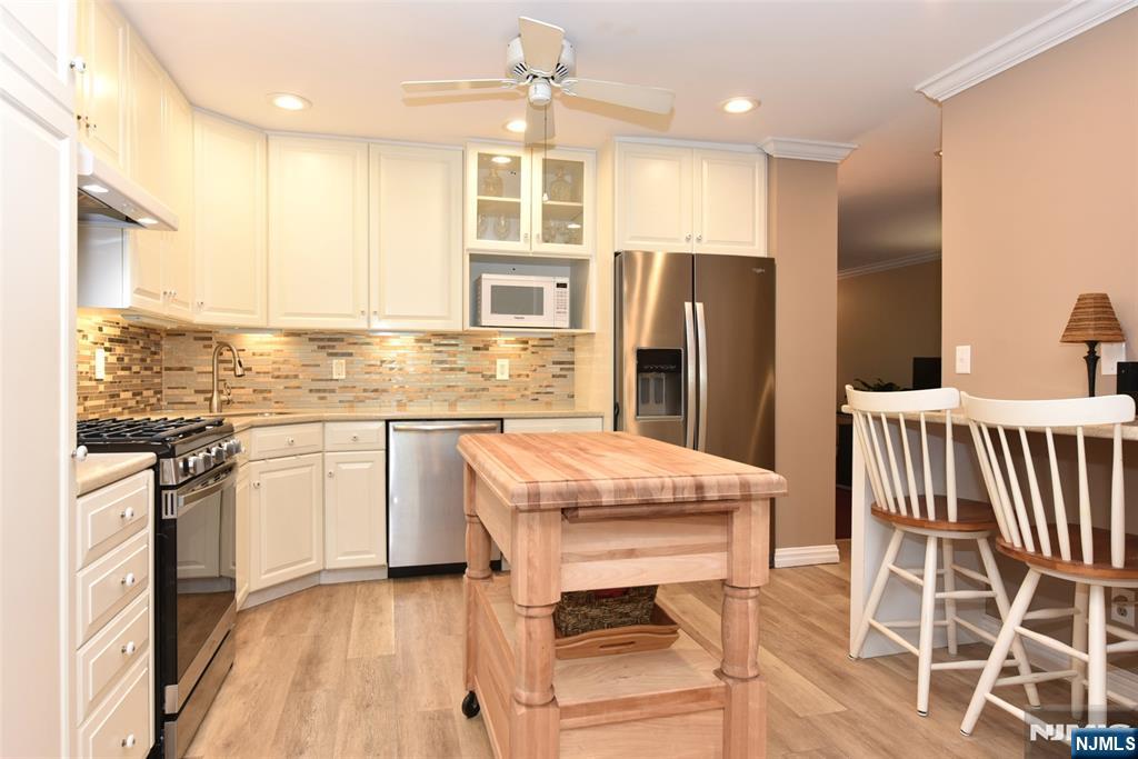 41 Litchult Lane Mahwah, NJ 07430 - Photo 11 of 50 a kitchen with stainless steel appliances granite countertop a stove refrigerator sink microwave and cabinets