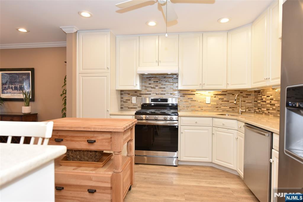 41 Litchult Lane Mahwah, NJ 07430 - Photo 12 of 50 a kitchen with stainless steel appliances granite countertop a stove a sink and a refrigerator