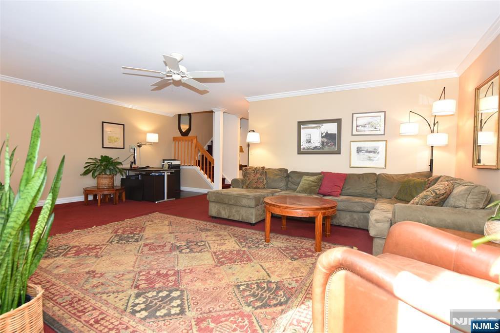 41 Litchult Lane Mahwah, NJ 07430 - Photo 16 of 50 a living room with furniture and a flat screen tv