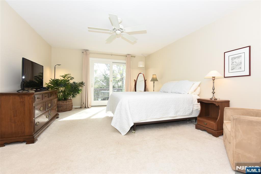 41 Litchult Lane Mahwah, NJ 07430 - Photo 20 of 50 a bedroom with a bed and a flat screen tv