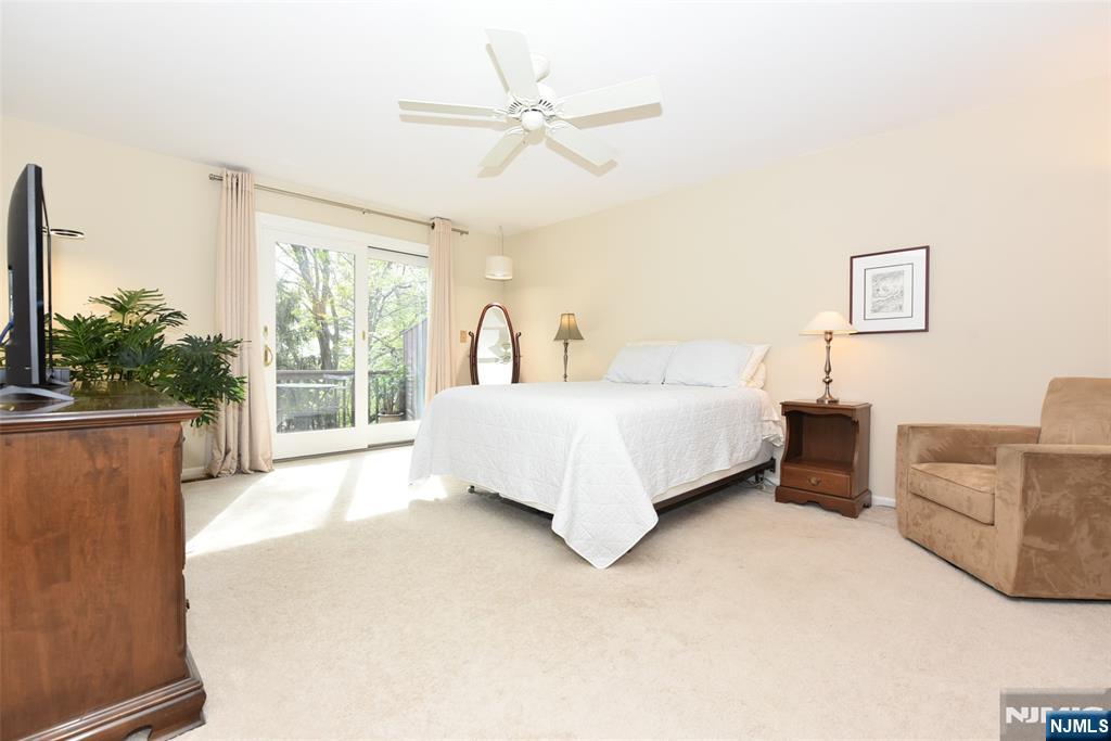 41 Litchult Lane Mahwah, NJ 07430 - Photo 21 of 50 a spacious bedroom with a bed and a couch