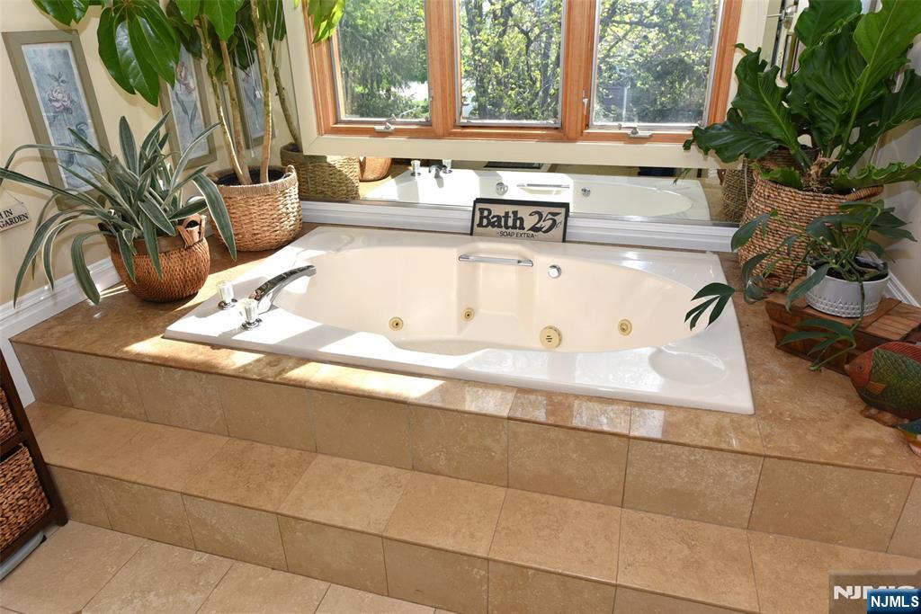 41 Litchult Lane Mahwah, NJ 07430 - Photo 25 of 50 a living room with a couch and a potted plant