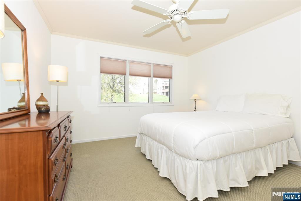 41 Litchult Lane Mahwah, NJ 07430 - Photo 28 of 50 a bedroom with a bed mirror and window