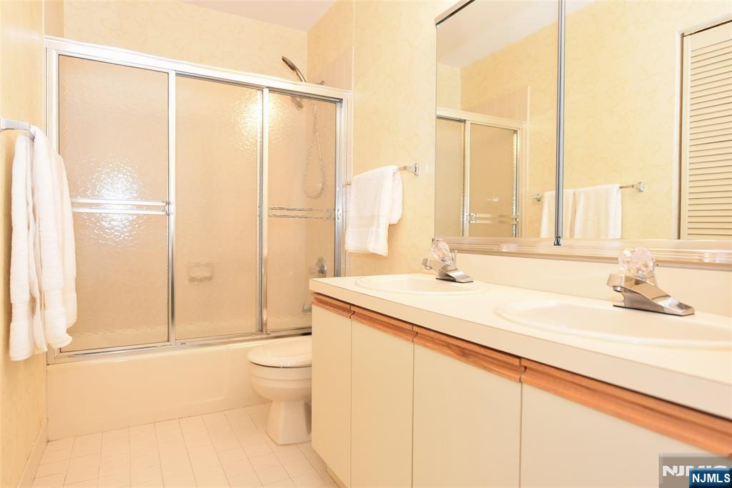 41 Litchult Lane Mahwah, NJ 07430 - Photo 30 of 50 a bathroom with a granite countertop sink a toilet and a mirror