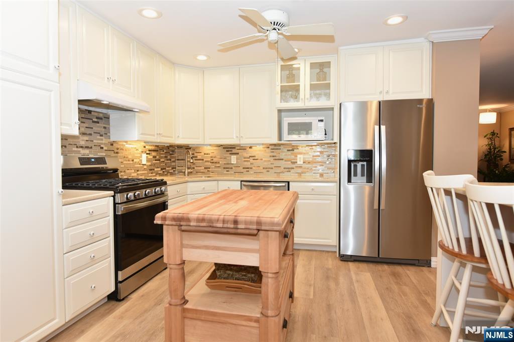 41 Litchult Lane Mahwah, NJ 07430 - Photo 10 of 50 a kitchen with stainless steel appliances granite countertop a refrigerator and a stove top oven