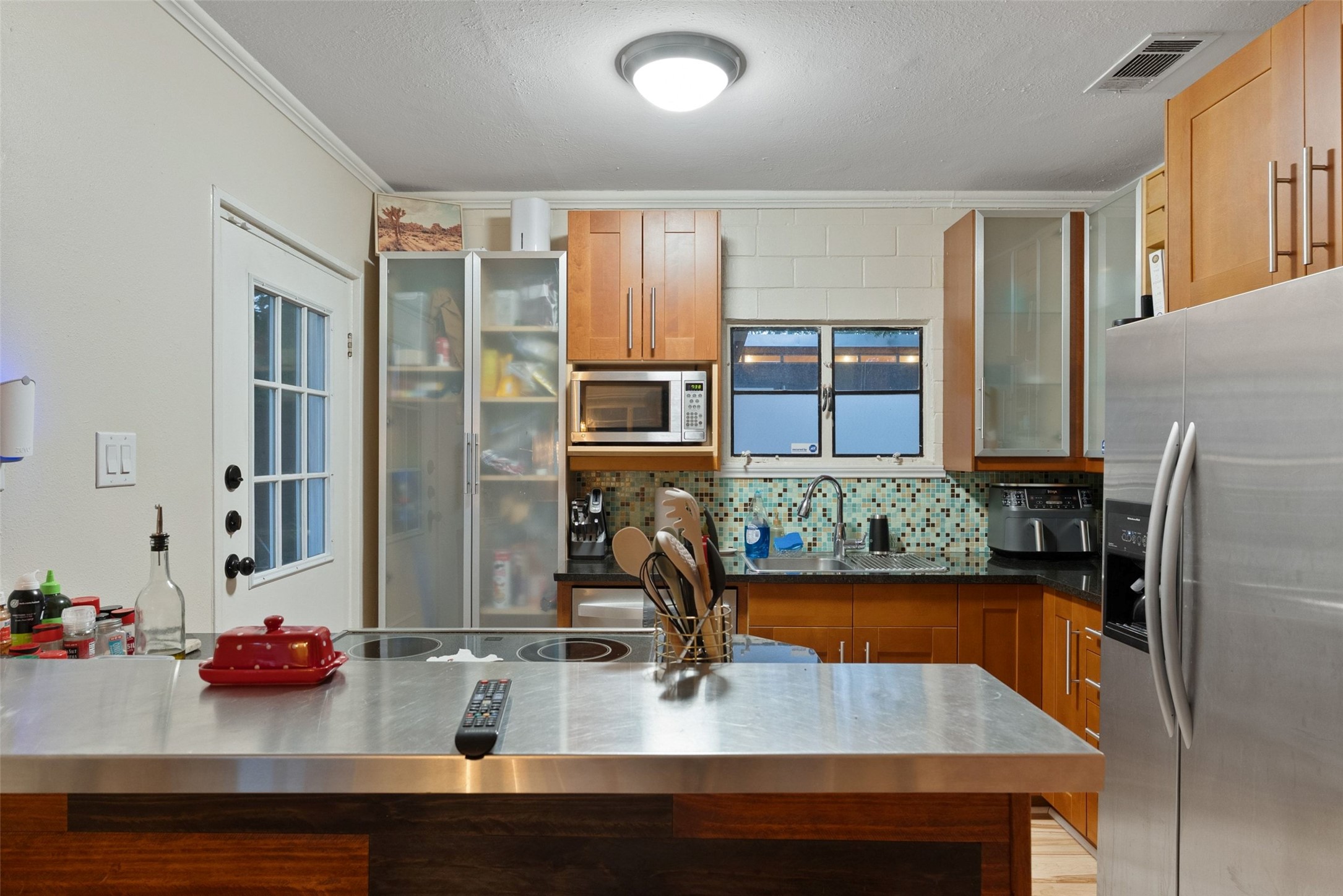412 West Croslin Street Austin, TX 78752 - Photo 8 of 36 A well-equipped culinary space offers ample counter space and integrated stainless steel appliances.