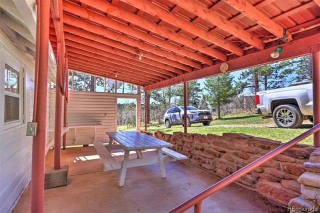 a backyard of a house with barbeque oven fire pit table and chairs