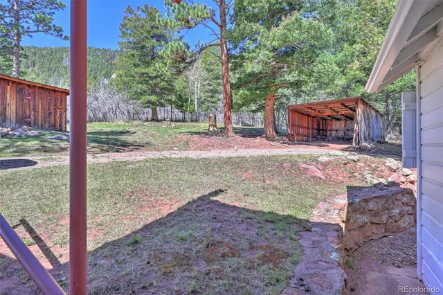 a view of a hallway with wooden floor and cabinet