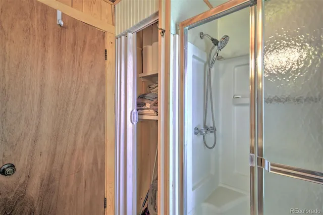 a bathroom with a glass shower door
