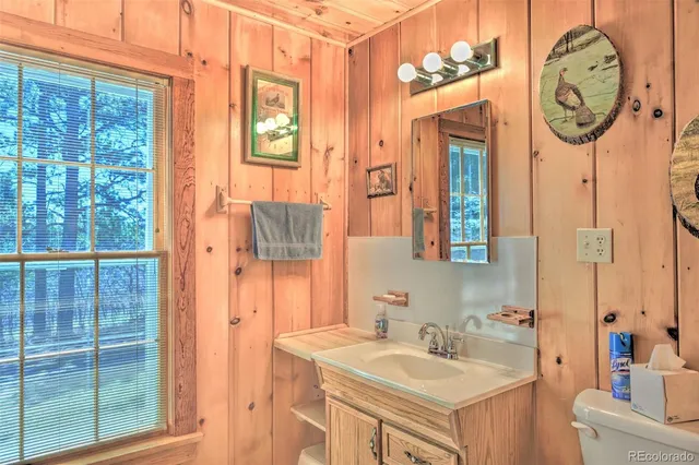 a view of a hallway with a large window and wooden floor