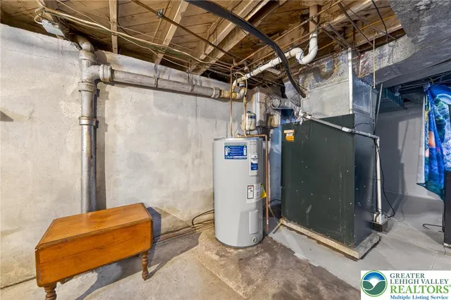 a utility room with dryer and a table