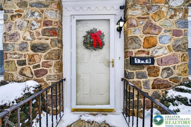 a view of a hallway with wooden door