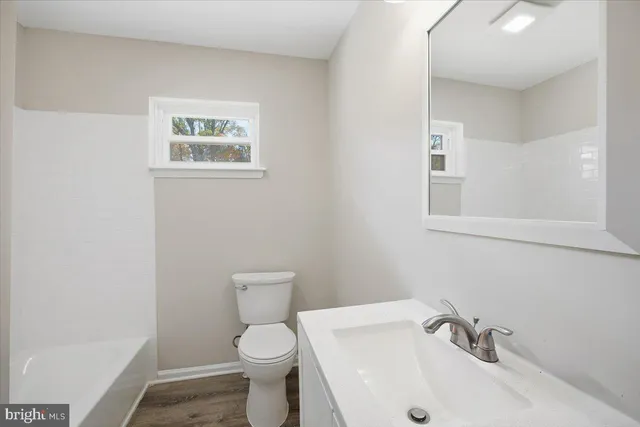 a white toilet sitting next to a bathroom sink