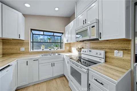 a kitchen that has a sink and a stove
