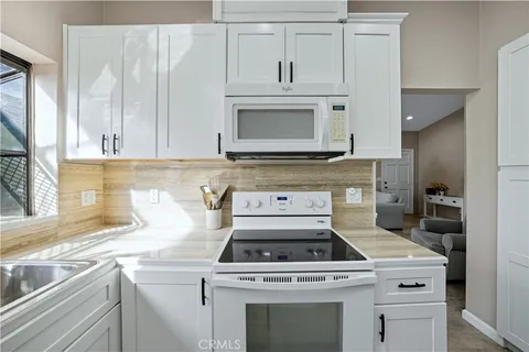 a kitchen with cabinets appliances and a sink