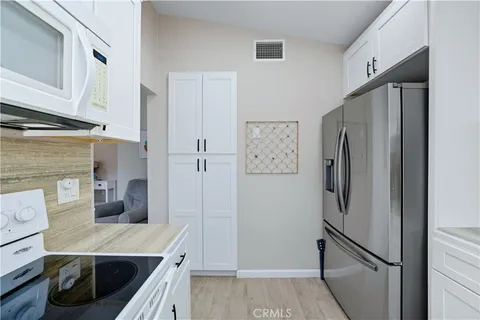 a kitchen with stainless steel appliances a refrigerator and a stove