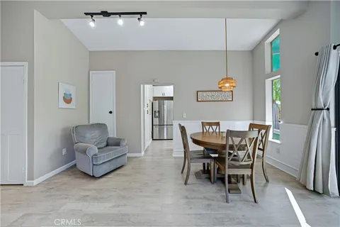 a view of a dining room with furniture and a chandelier