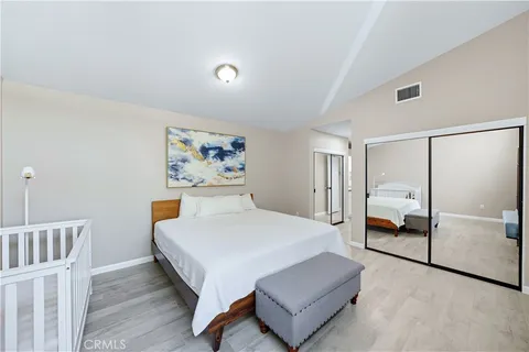 a spacious bedroom with a bed and window