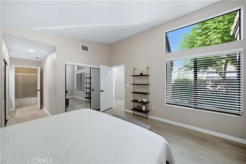 a bedroom with a bed and a large window