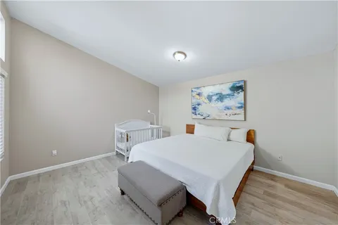 a view of bedroom with furniture and wooden floor