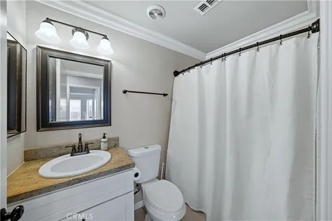 a bathroom with a sink toilet a mirror and a shower