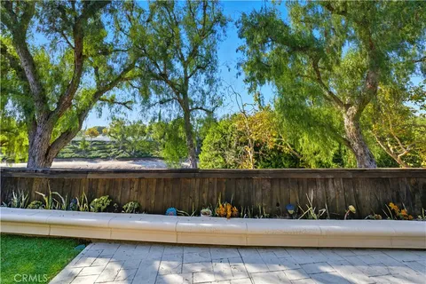 a view of garden with tree in the background