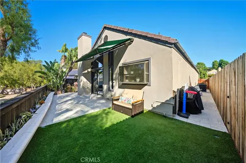 a view of a house with backyard and porch