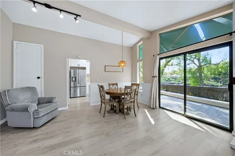 a dining room with furniture window and wooden floor