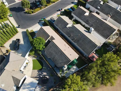 an aerial view of a house with a yard and potted plants