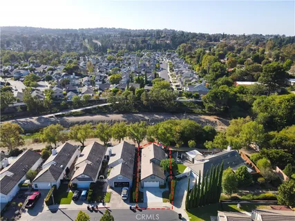 an aerial view of residential houses with outdoor space and swimming pool