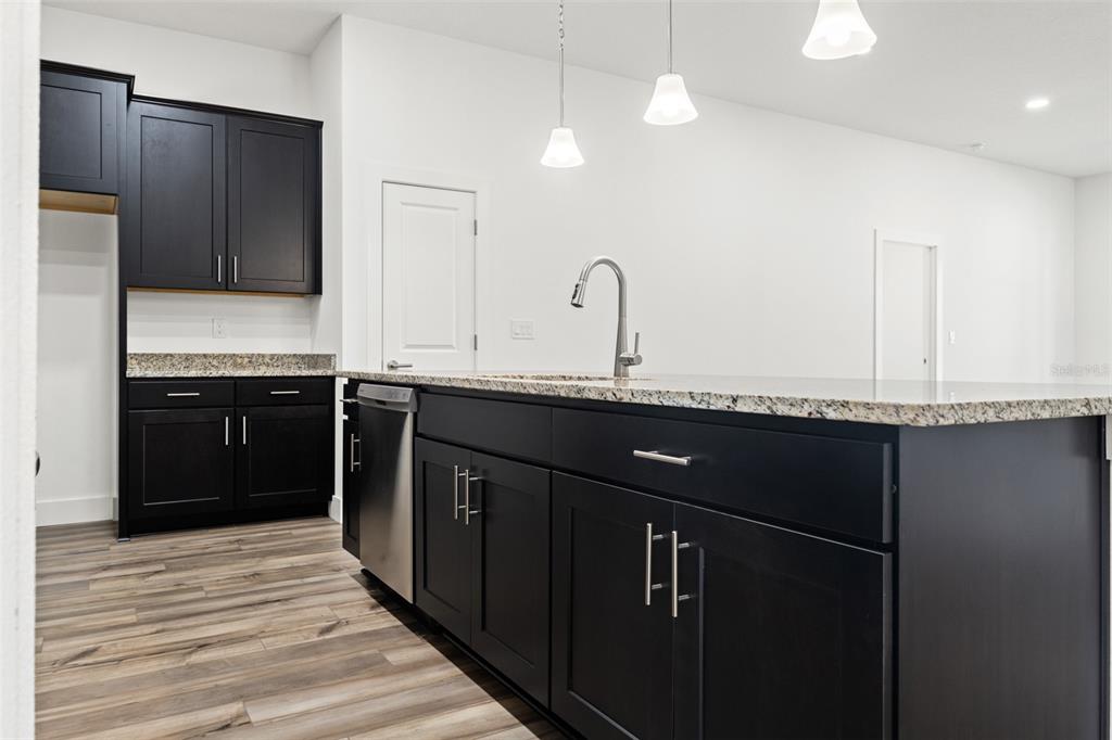 15171 Pomp Parkway Weeki Wachee, FL 34614 - Photo 17 of 50 a kitchen with a sink and a refrigerator