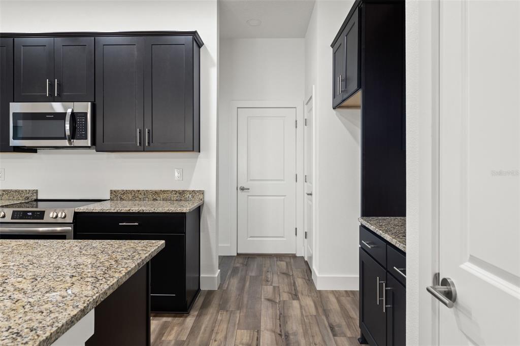 15171 Pomp Parkway Weeki Wachee, FL 34614 - Photo 19 of 50 a kitchen with granite countertop stainless steel appliances and wooden cabinets