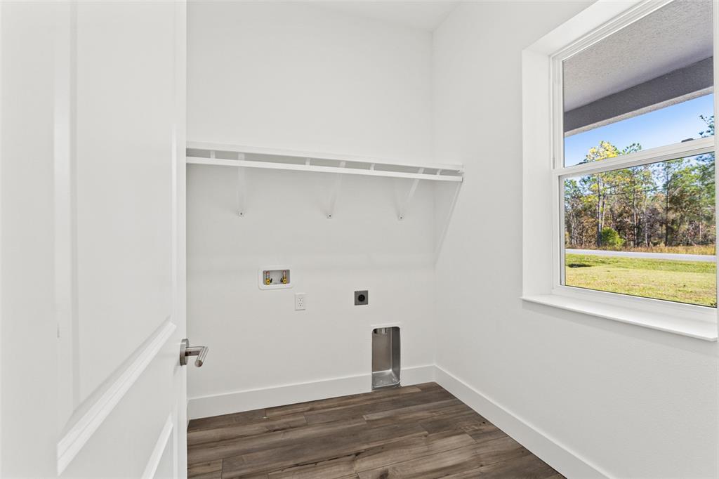 15171 Pomp Parkway Weeki Wachee, FL 34614 - Photo 20 of 50 a view of an empty room with wooden floor and a window