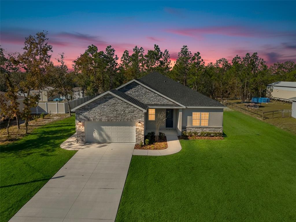 15171 Pomp Parkway Weeki Wachee, FL 34614 - Photo 2 of 50 a front view of a house with a yard