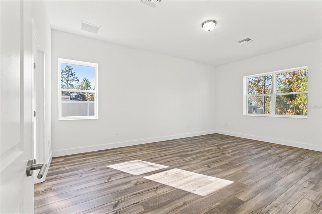 15171 Pomp Parkway Weeki Wachee, FL 34614 - Photo 26 of 50 wooden floor in an empty room with a window