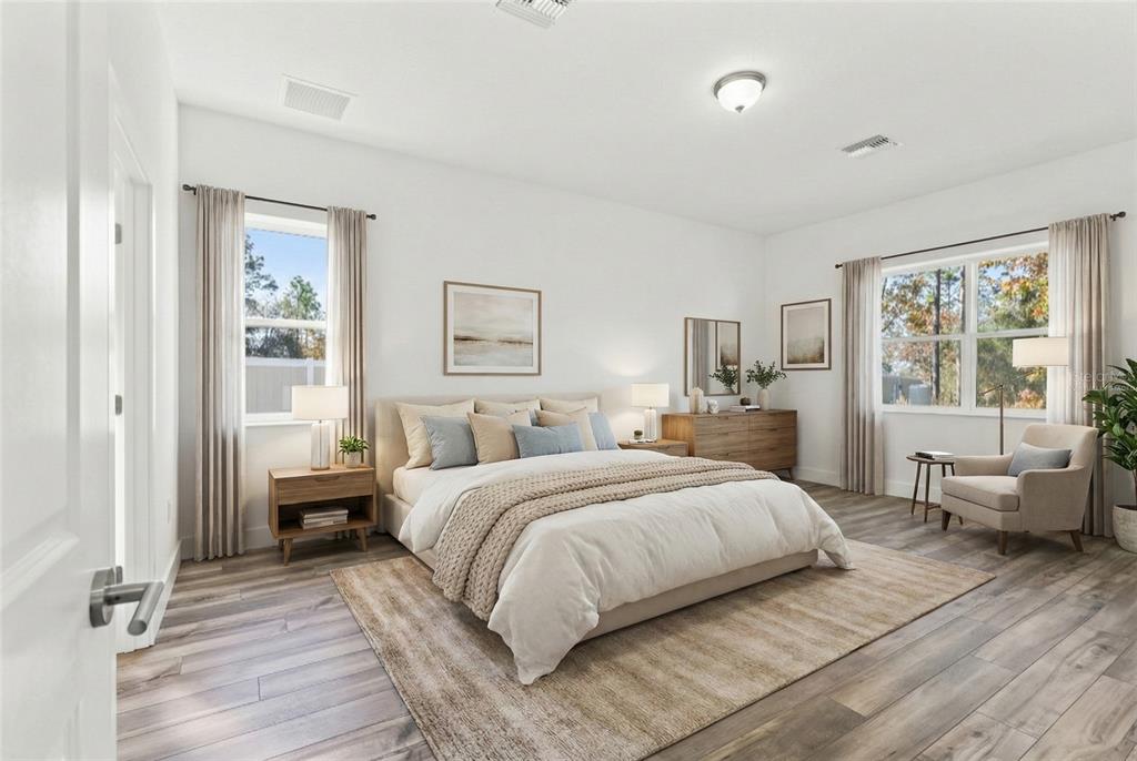 15171 Pomp Parkway Weeki Wachee, FL 34614 - Photo 27 of 50 a bedroom with a large bed and windows