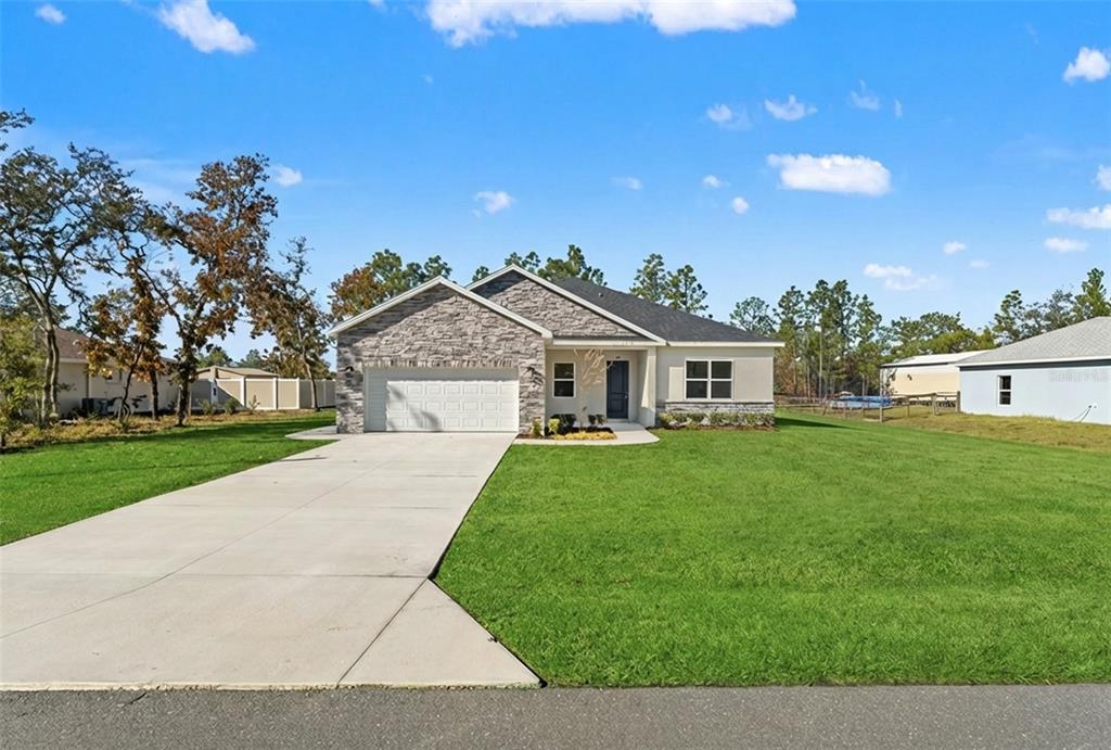15171 Pomp Parkway Weeki Wachee, FL 34614 - Photo 3 of 50 a front view of house with yard and green space