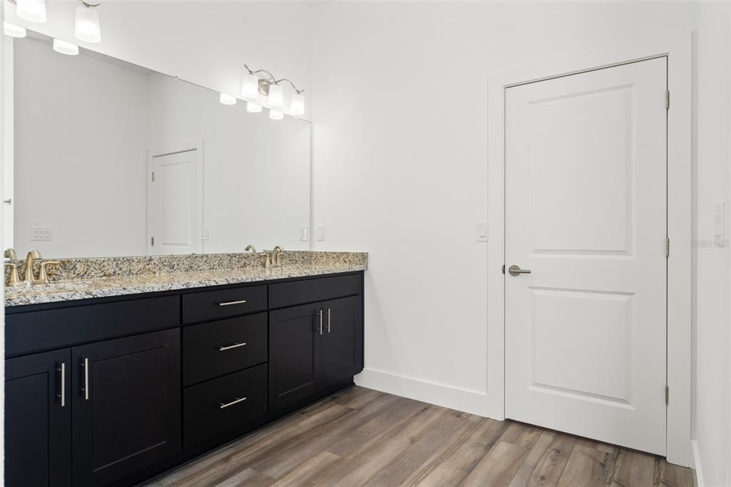 15171 Pomp Parkway Weeki Wachee, FL 34614 - Photo 31 of 50 a bathroom with a granite countertop sink and a mirror