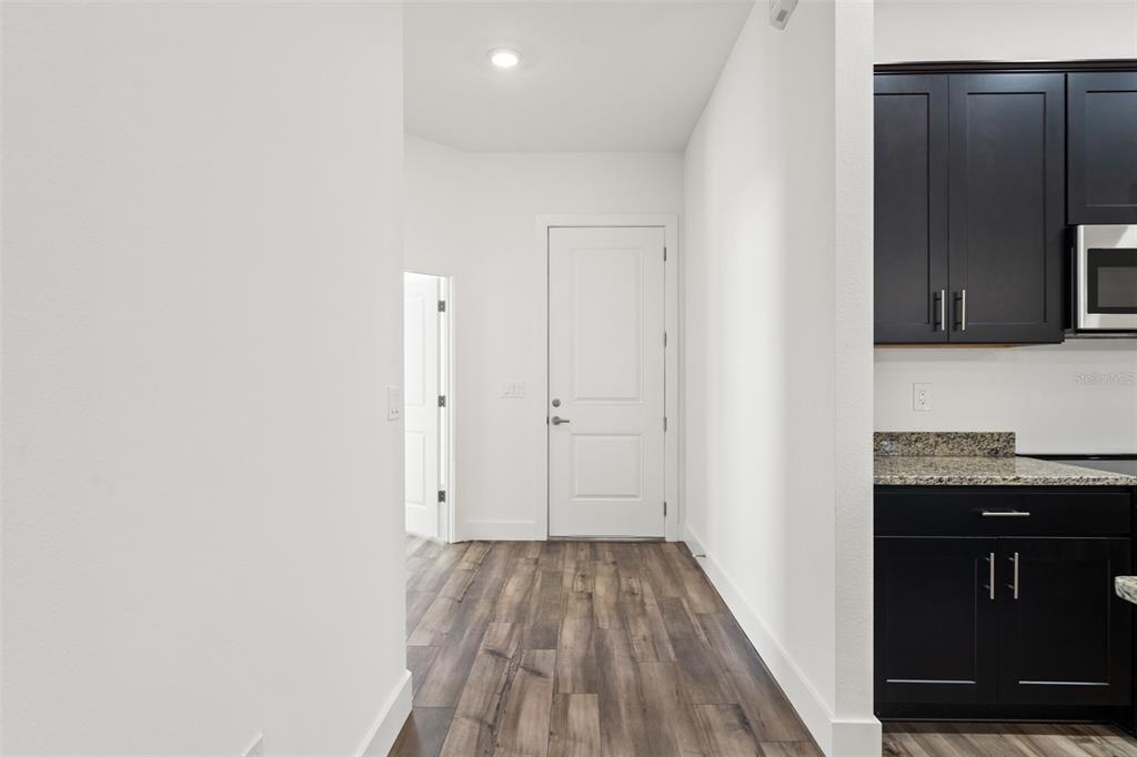 15171 Pomp Parkway Weeki Wachee, FL 34614 - Photo 6 of 50 a view of kitchen with granite countertop cabinets and black appliances