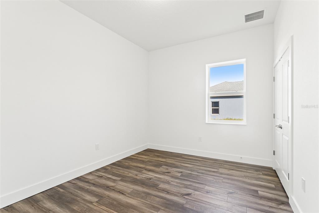 15171 Pomp Parkway Weeki Wachee, FL 34614 - Photo 10 of 50 a view of a room with wooden floor and white walls