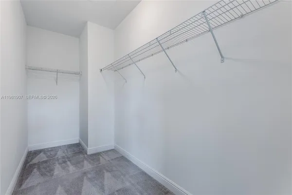 an empty room with windows and entrance