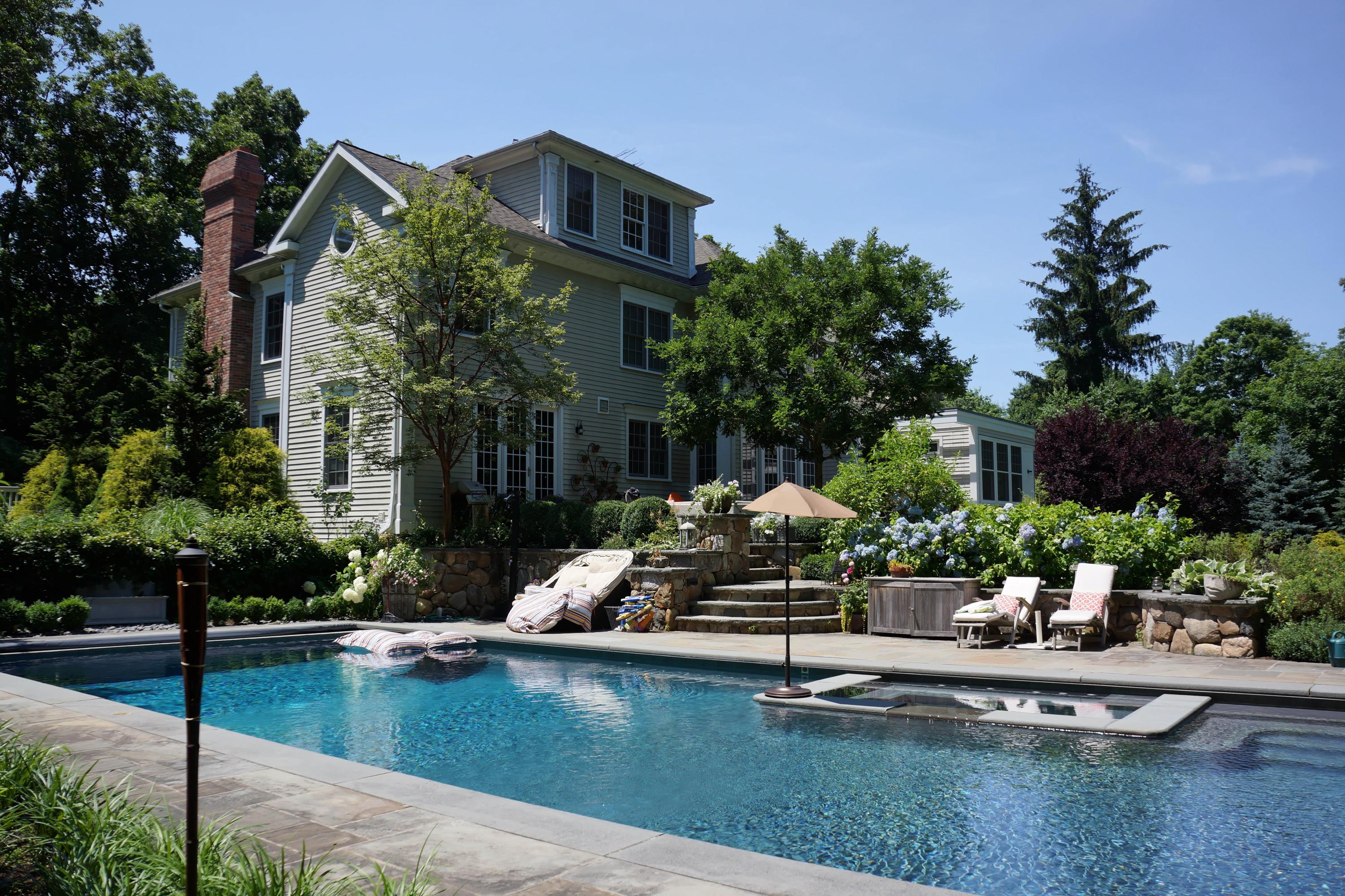 276 White Oak Shade Road New Canaan, CT 06840 - Photo 23 of 36 a view of a swimming pool with a lounge chairs